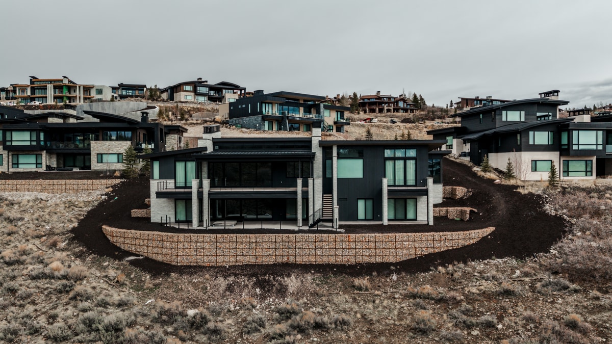 Pinnacle Lot 47 Park City Utah — aerial front facade showcasing multi-level contemporary architecture with floor-to-ceiling glazing
