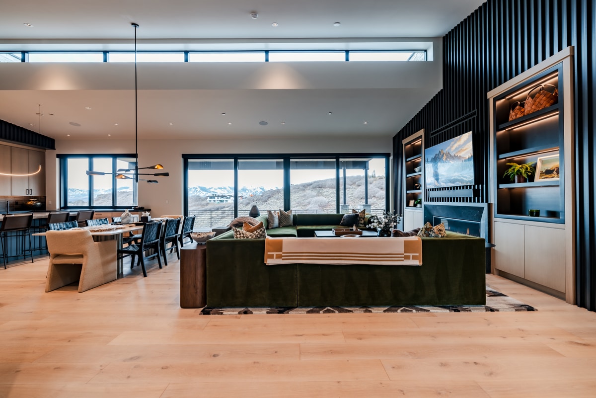 Pinnacle Lot 47 Park City Utah — full open-plan overview of kitchen, dining, and living under clerestory light with Wasatch panorama