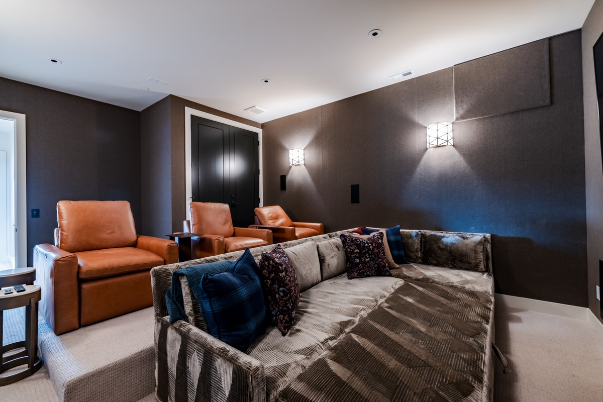 Pinnacle Lot 47 Park City Utah — dedicated home theater with acoustic wall panels, tiered leather recliners, and plush sectional