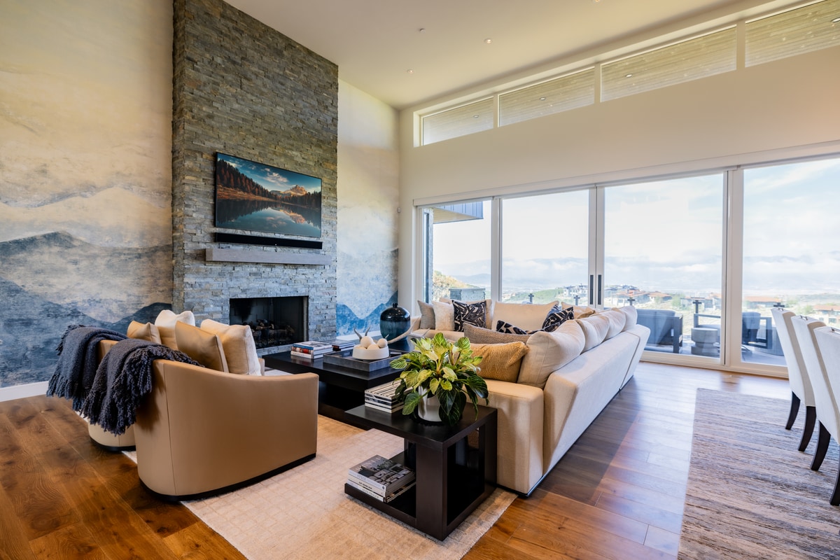 Promontory Lot 52 Park City Utah — great room with stacked-stone fireplace surround, mountain-view windows, and white oak flooring