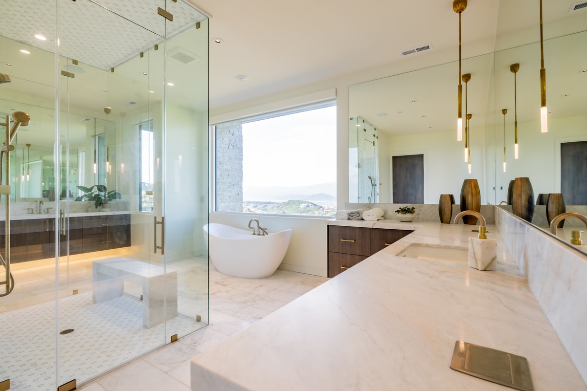 Promontory Lot 52 Park City Utah — spa bath with book-matched marble countertop, frameless glass shower, and golf course views
