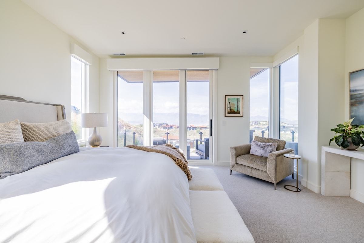 Promontory Lot 52 Park City Utah — sun-filled secondary bedroom with sliding glass doors to private balcony and valley views