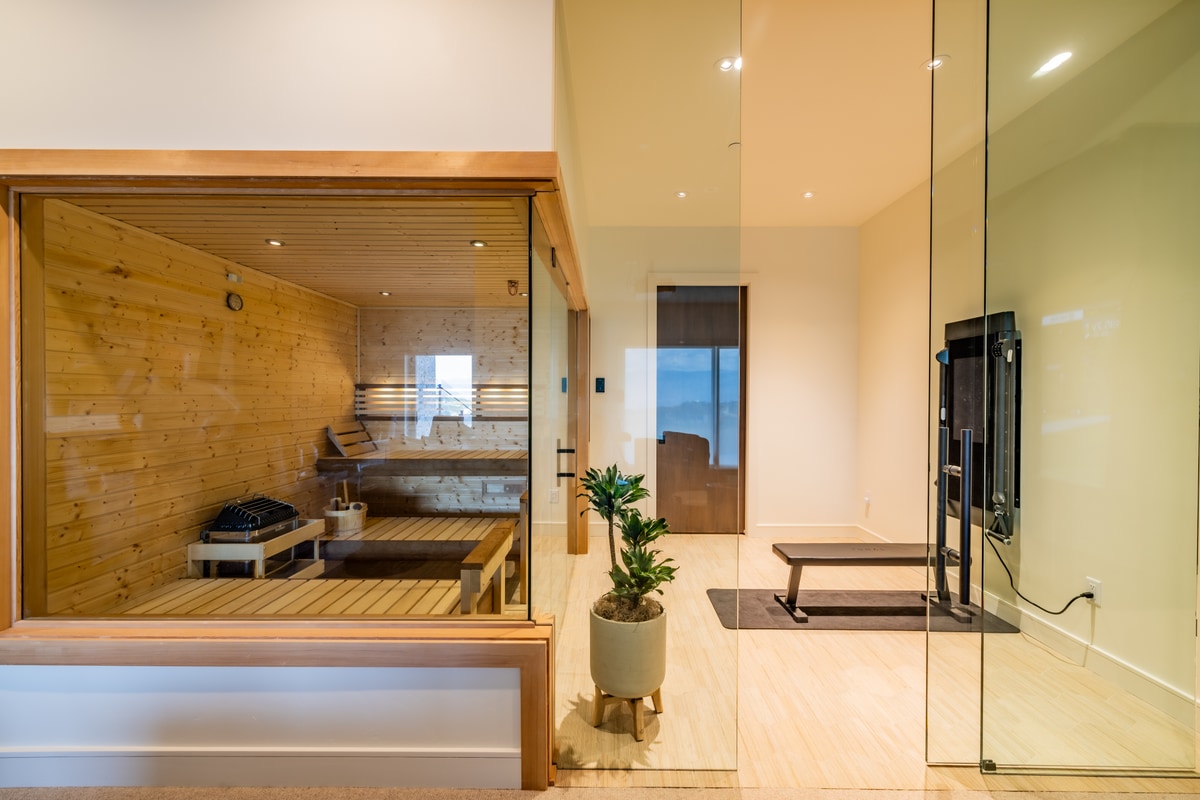 Promontory Lot 52 Park City Utah — glass-enclosed cedar sauna and fitness studio with mirrored panels and mountain-view windows