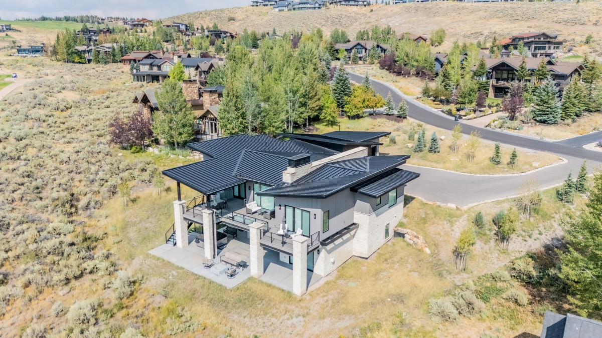 Ranch Gardens Park City Utah — aerial view of custom home with standing-seam metal roof and sage-covered hillside