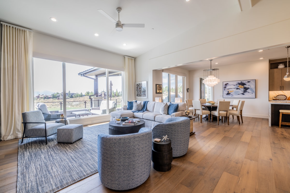 Ranch Gardens Park City Utah — expansive great room with wide-plank hardwood floors, floor-to-ceiling windows, and open dining area
