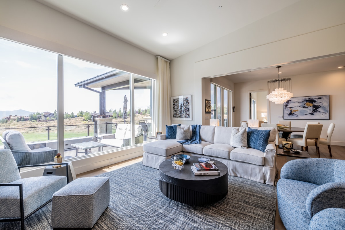 Ranch Gardens Park City Utah — living room with panoramic sliding glass doors opening to covered terrace with golf course views