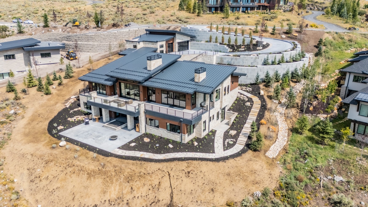 Summit Estates Park City Utah — aerial view of custom home with multi-level roofline, stone masonry, and circular driveway