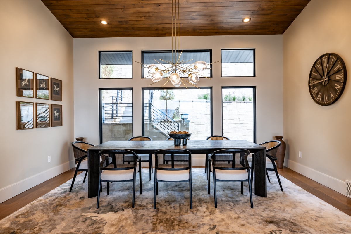 Summit Estates Park City Utah — formal dining room with stained wood plank ceiling, globe chandelier, and ten-seat hardwood table