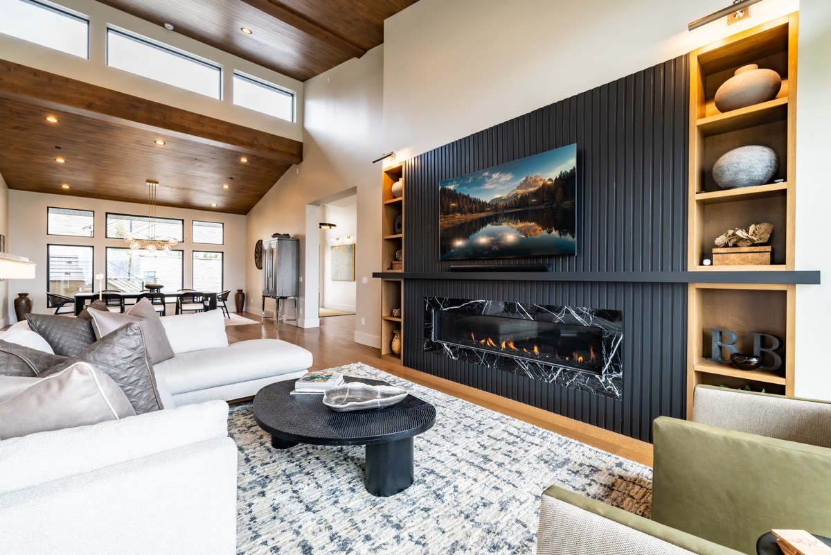 Summit Estates Park City Utah — living room with black slat feature wall, linear marble fireplace, and built-in oak shelving